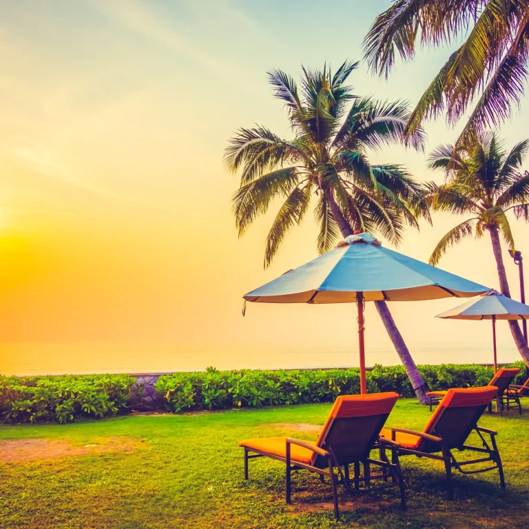 blue-umbrella-sea-chairs-sky